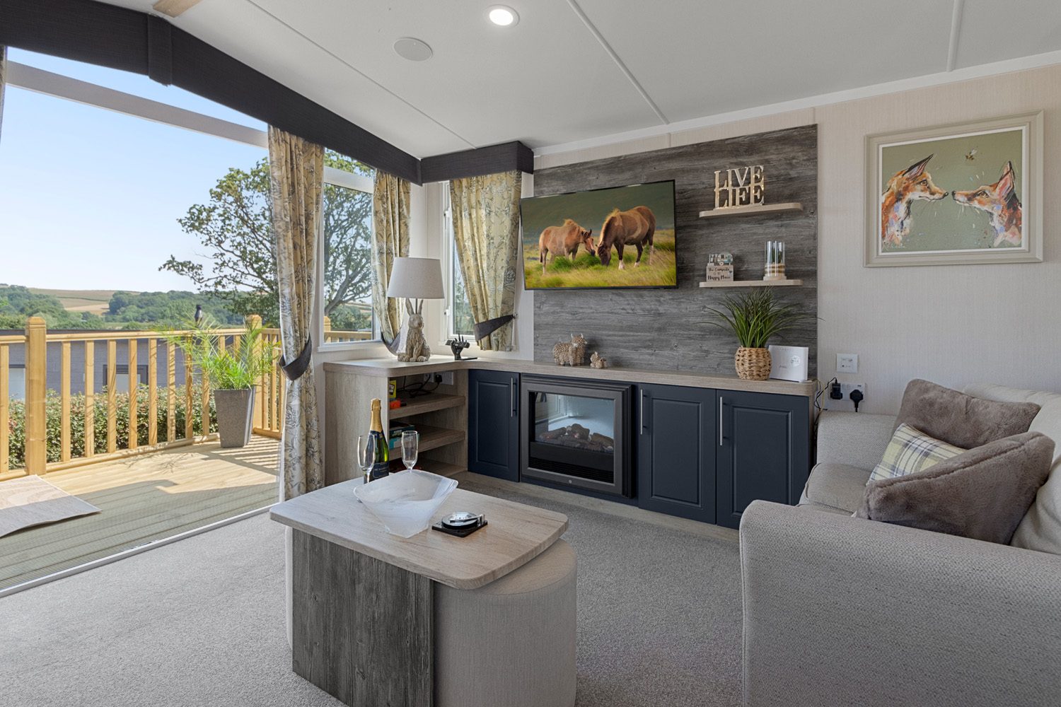 Lounge with electric fireplace and countryside view