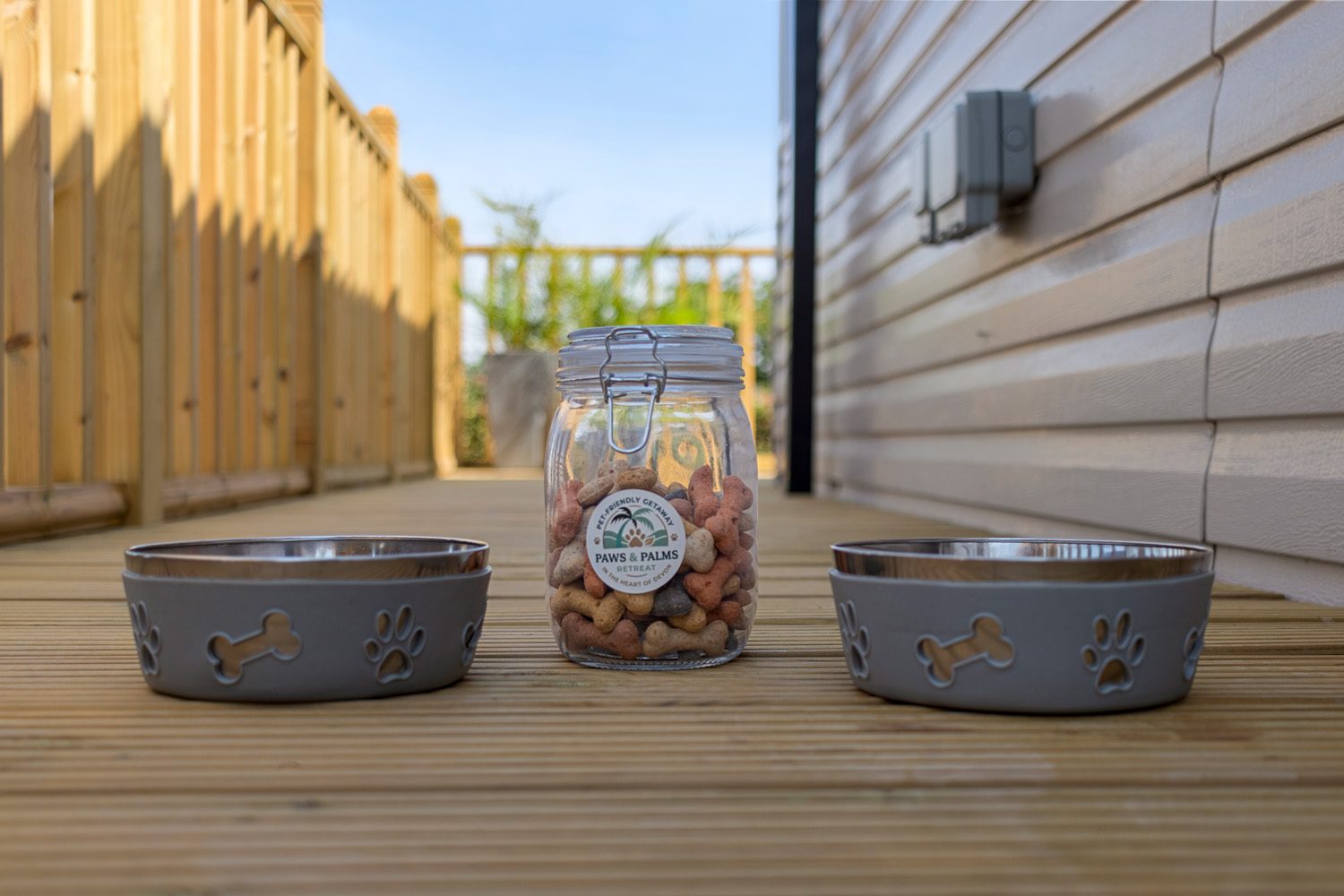 Dog bowls and a jar of dog treats on the terrace
