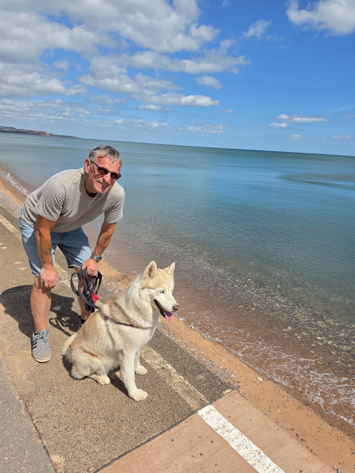 Guest and husky by the water's edge