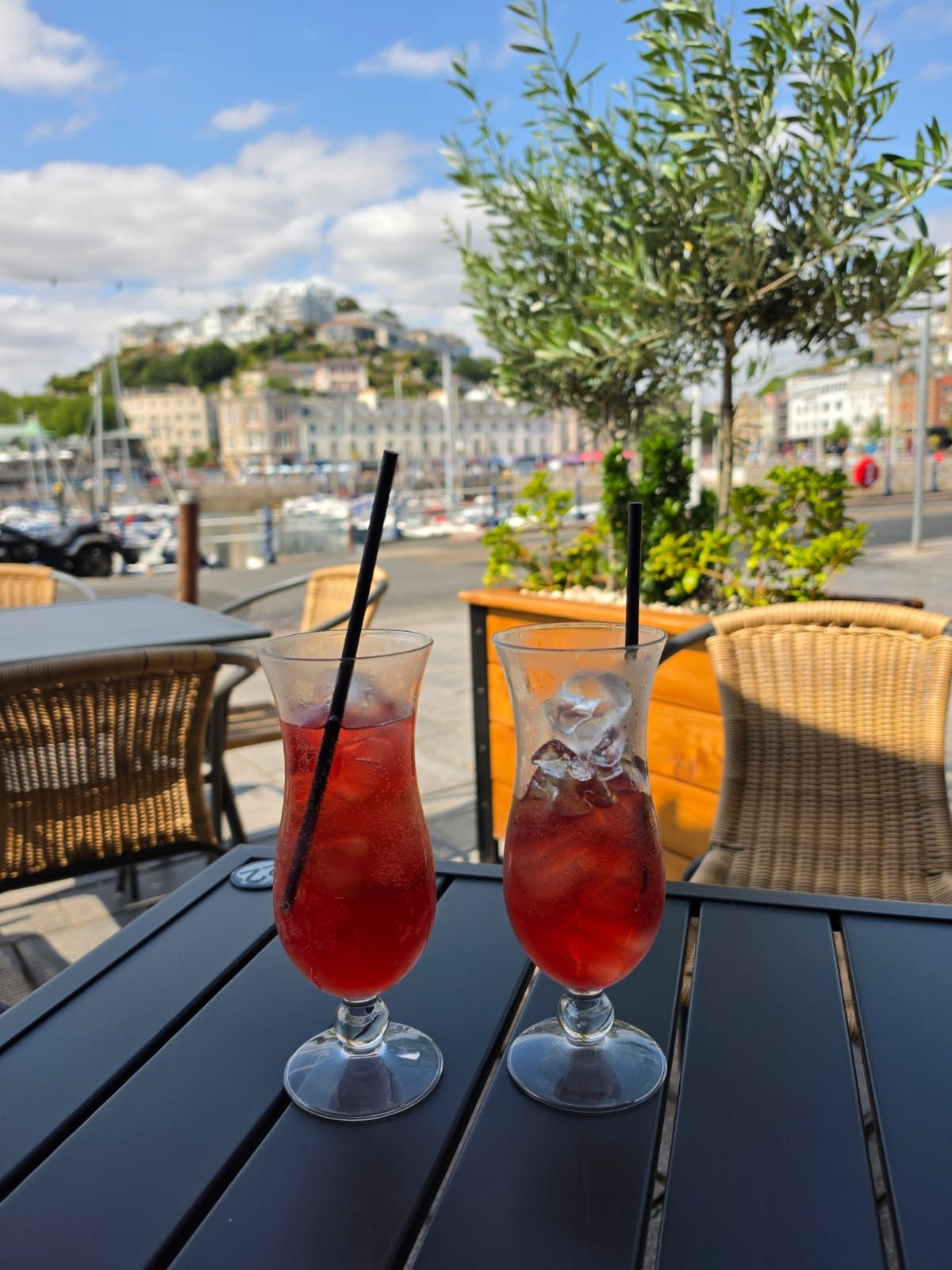 Two drinks on a table overlooking Torquay harbour